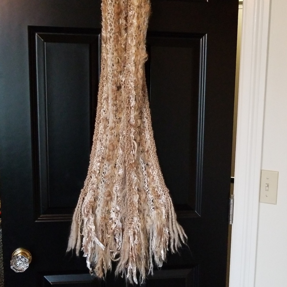 Beautiful and fuzzy and soft hand knitted scarf.